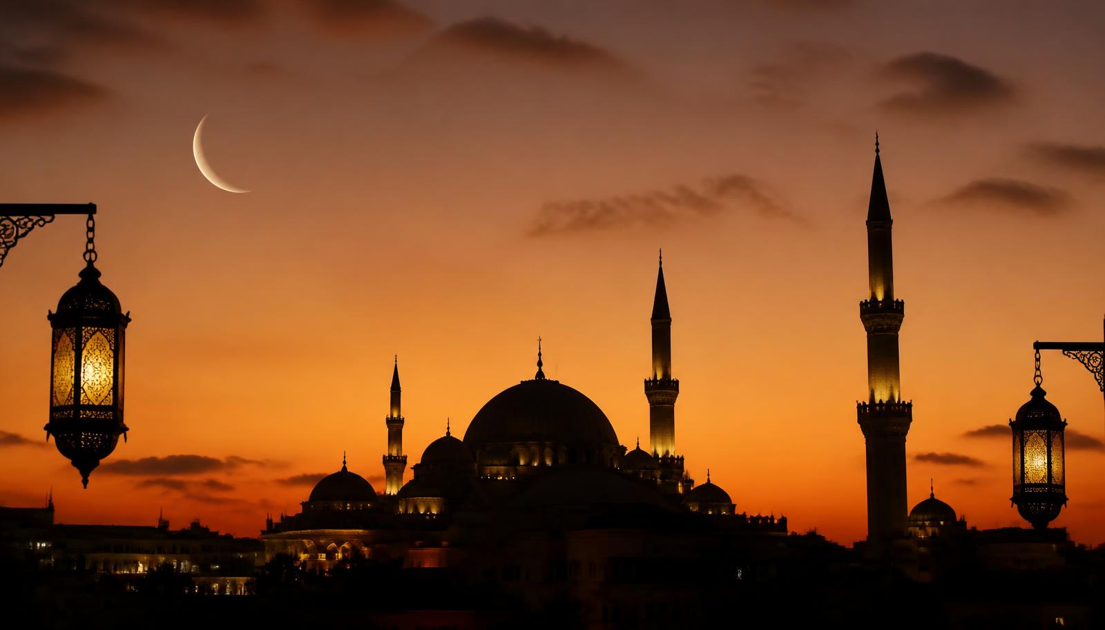 Mosque silhouette with a crescent moon at dusk during Ramadan